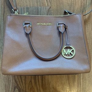 Michael Kors medium sized purse that includes a cross body strap